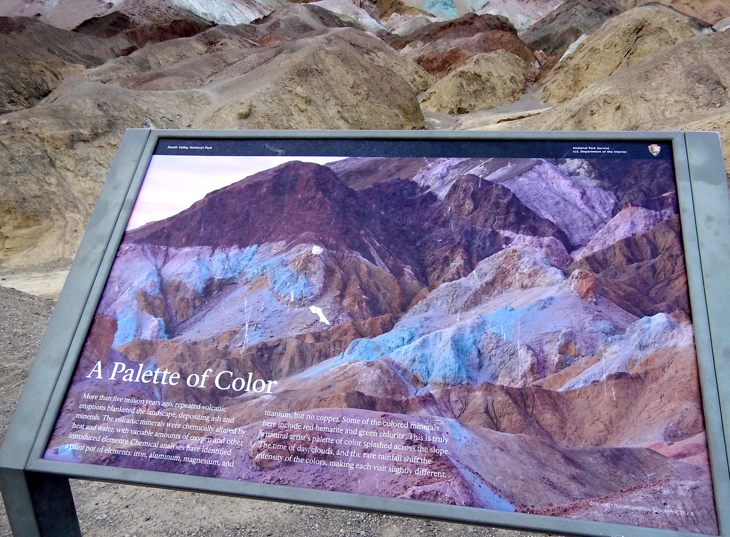 Sign explaining why the rocks are colored.